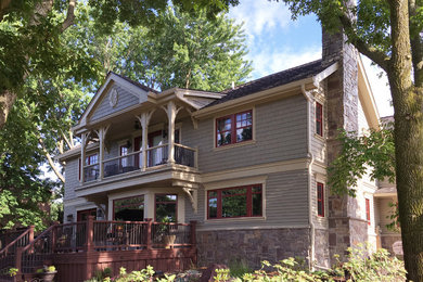 Large transitional gray two-story wood gable roof idea in Milwaukee