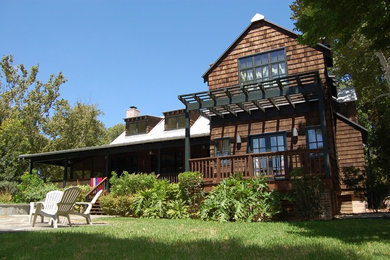 Example of a mid-sized mountain style brown two-story wood exterior home design in Houston with a shingle roof