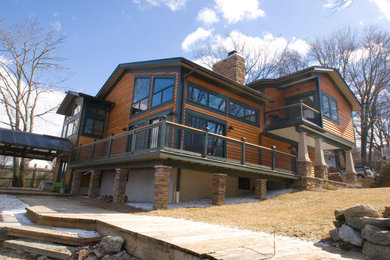 Example of a mountain style brown two-story wood gable roof design