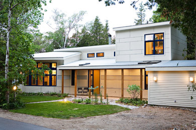 Example of a beach style white two-story exterior home design in Toronto