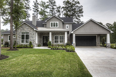 Large elegant gray two-story mixed siding exterior home photo in Houston with a shingle roof