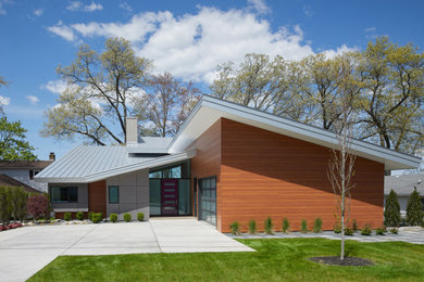Mid-sized contemporary multicolored two-story mixed siding house exterior idea in Grand Rapids with a metal roof and a gray roof