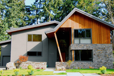 This is an example of a contemporary house exterior in Portland with wood cladding.