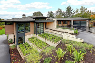 Large trendy multicolored two-story mixed siding exterior home photo in Portland with a green roof