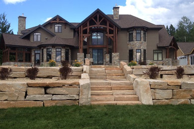 Beige two-story stone exterior home idea in Toronto
