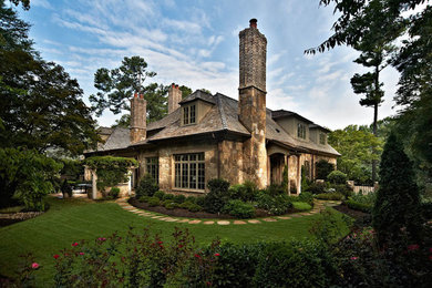 Expansive and brown rustic bungalow house exterior in Raleigh with stone cladding.