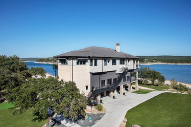 Diseño de fachada de casa gris y gris costera grande de tres plantas con revestimientos combinados, tejado a cuatro aguas, tejado de metal y panel y listón