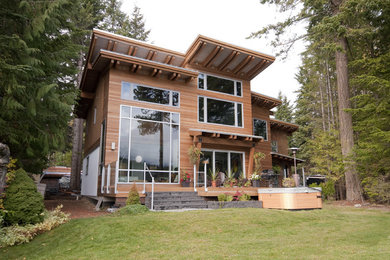Example of a trendy wood exterior home design in Vancouver