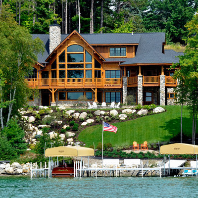 Example of a large mountain style brown three-story mixed siding exterior home design in Other with a shingle roof