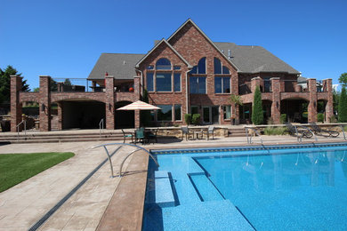 Example of a large classic brown two-story brick exterior home design in Other with a shingle roof
