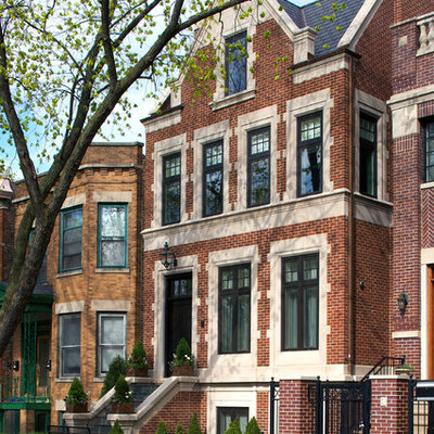 Large elegant brown three-story brick exterior home photo in Chicago