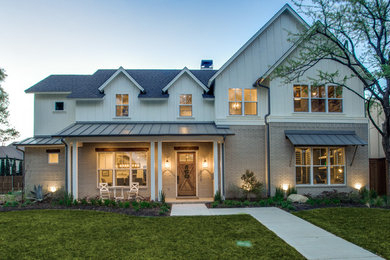 This is an example of a medium sized and beige farmhouse two floor house exterior in Dallas with a pitched roof and mixed cladding.