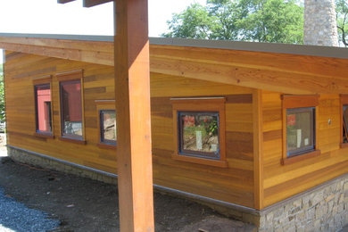 Example of a mid-sized minimalist brown wood house exterior design in Philadelphia with a shed roof