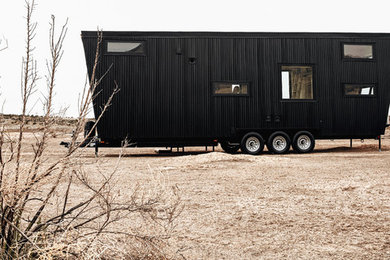 Small minimalist black two-story metal house exterior photo in Denver with a shed roof