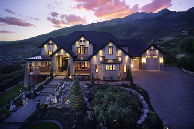 Example of a huge arts and crafts beige three-story mixed siding house exterior design in Salt Lake City with a hip roof and a shingle roof