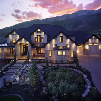 Example of a huge arts and crafts beige three-story mixed siding house exterior design in Salt Lake City with a hip roof and a shingle roof
