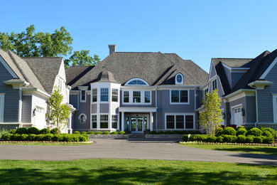 Large transitional gray three-story wood house exterior photo in Detroit with a hip roof and a shingle roof