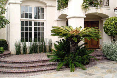 Tuscan beige two-story stucco exterior home photo in Orange County