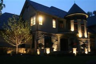 Inspiration for a huge timeless beige three-story stucco exterior home remodel in Milwaukee with a clipped gable roof