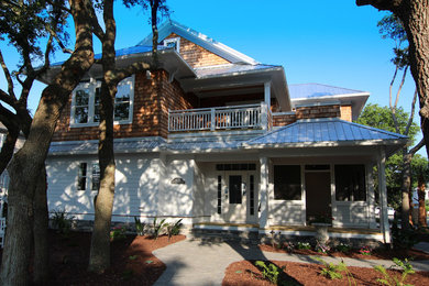 Esempio della villa bianca stile marinaro a due piani di medie dimensioni con rivestimento in legno, tetto a padiglione e copertura in metallo o lamiera