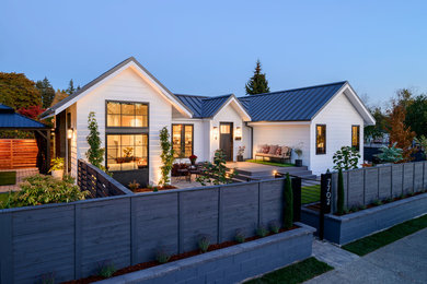 Mid-sized transitional white two-story mixed siding exterior home idea in Seattle with a metal roof