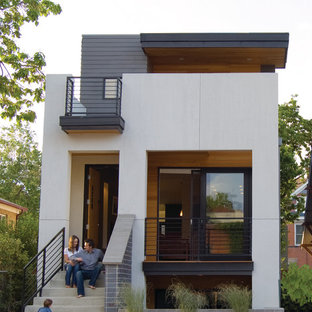 Ispirazione per la facciata di una casa bianca moderna a tre piani di medie dimensioni con rivestimento con lastre in cemento