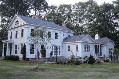 Inspiration for a mid-sized timeless white two-story mixed siding exterior home remodel in Boston with a shingle roof