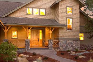 Example of a mountain style two-story wood exterior home design in Other