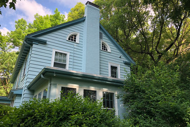 Example of a large 1960s blue two-story wood exterior home design in Boston with a shingle roof
