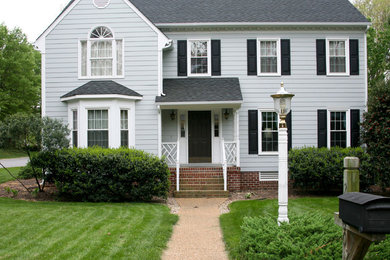 Inspiration for a large timeless blue two-story vinyl house exterior remodel in Richmond with a shingle roof