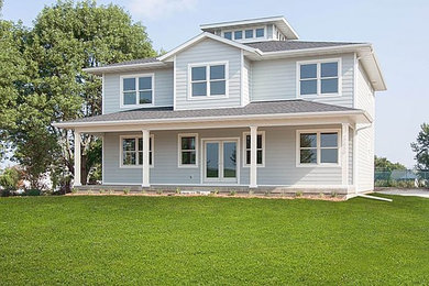 Mid-sized contemporary blue two-story concrete fiberboard exterior home idea in Chicago with a hip roof