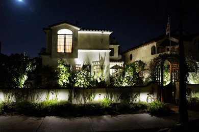 Example of a large tuscan beige two-story stucco exterior home design in San Diego with a tile roof