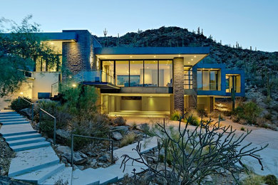Inspiration for a large modern beige two-story mixed siding exterior home remodel in Phoenix