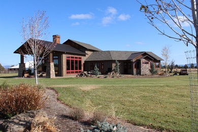 Example of a mid-sized country gray two-story mixed siding exterior home design in Other with a hip roof