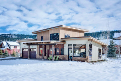 Inspiration for a mid-sized modern beige one-story house exterior remodel in Other