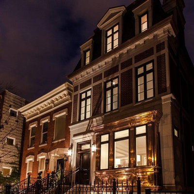 Large elegant brown three-story brick exterior home photo in Chicago