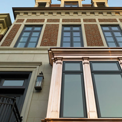 Inspiration for a large timeless brown three-story stone exterior home remodel in Chicago
