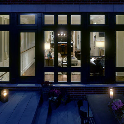 Inspiration for a large timeless brown three-story brick exterior home remodel in Chicago