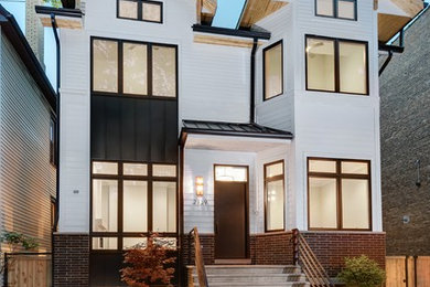 Example of a large trendy three-story house exterior design in Chicago
