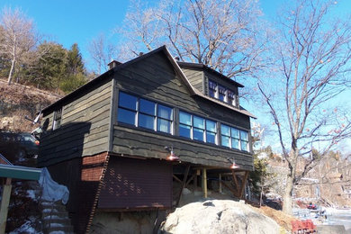 Small mountain style two-story wood gable roof photo in Burlington