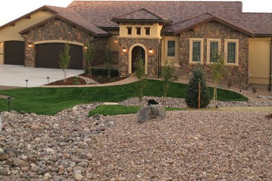 Example of a mid-sized tuscan exterior home design in Denver