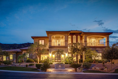 Huge trendy brown two-story stone exterior home photo in Las Vegas
