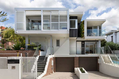 Example of a beach style duplex exterior design in Sydney