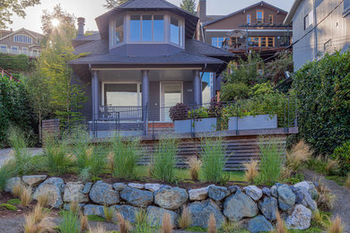Inspiration for a small craftsman gray two-story wood exterior home remodel in Seattle with a hip roof