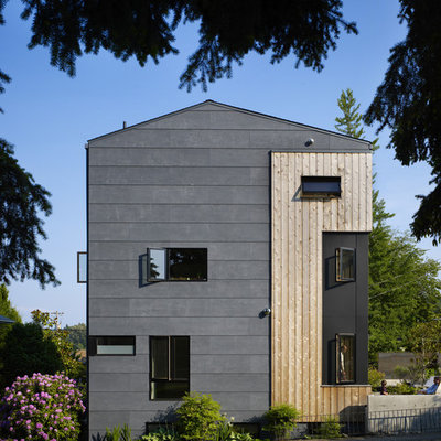 Inspiration for a mid-sized contemporary gray three-story mixed siding gable roof remodel in Seattle