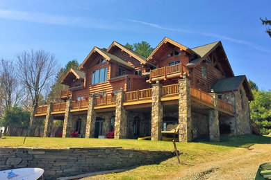 Mountain style brown three-story wood gable roof photo in Other