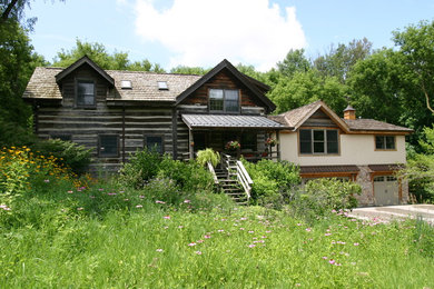 Photo of a rustic two floor house exterior in Chicago with wood cladding.