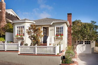 Small beach style beige one-story exterior home photo in Orange County with a hip roof