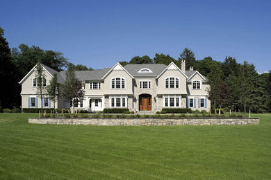 Large elegant beige two-story mixed siding house exterior photo in New York with a hip roof and a shingle roof