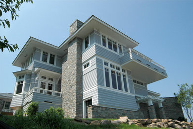 Inspiration for a huge contemporary blue two-story concrete fiberboard exterior home remodel in Boston with a hip roof